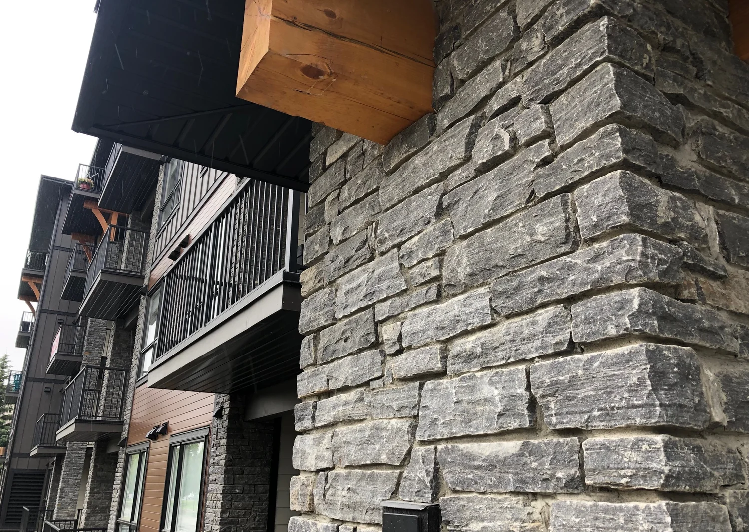 A Silver Pearl pier turns beneath a heavy timber bracket, balconies stepping away behind.