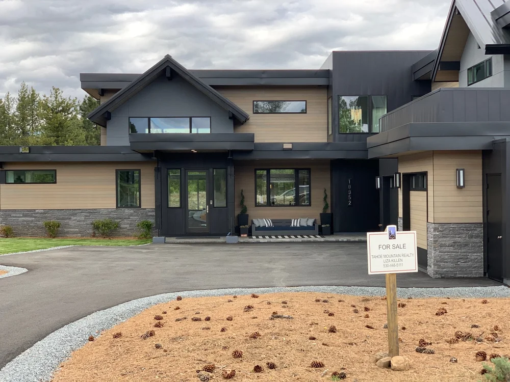 Silver Pearl bands the base of a mountain house in tan siding and dark metal.