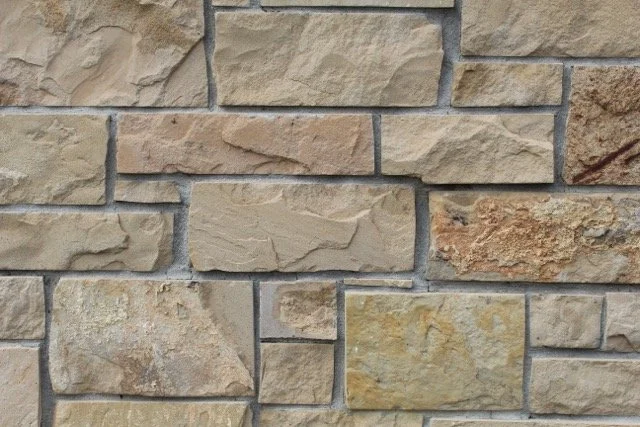 Tan ashlar veneer sample in split face.