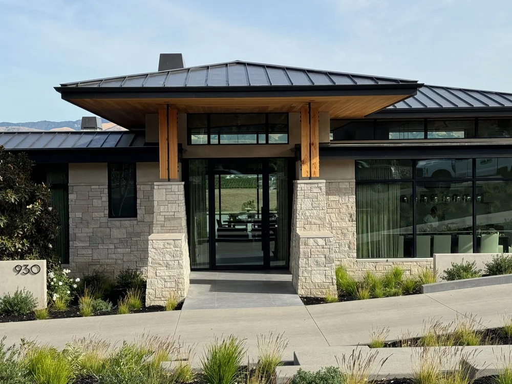 Indiana Limestone ashlar veneer in split face, finished with honed Indiana Limestone wall caps, column caps, wainscot caps, and sills at the entry.