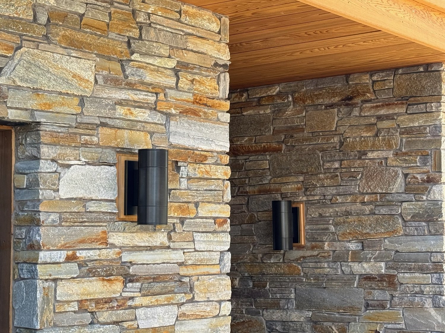 Autumn Mountain ledgestone veneer in split and natural faces across a home facade.