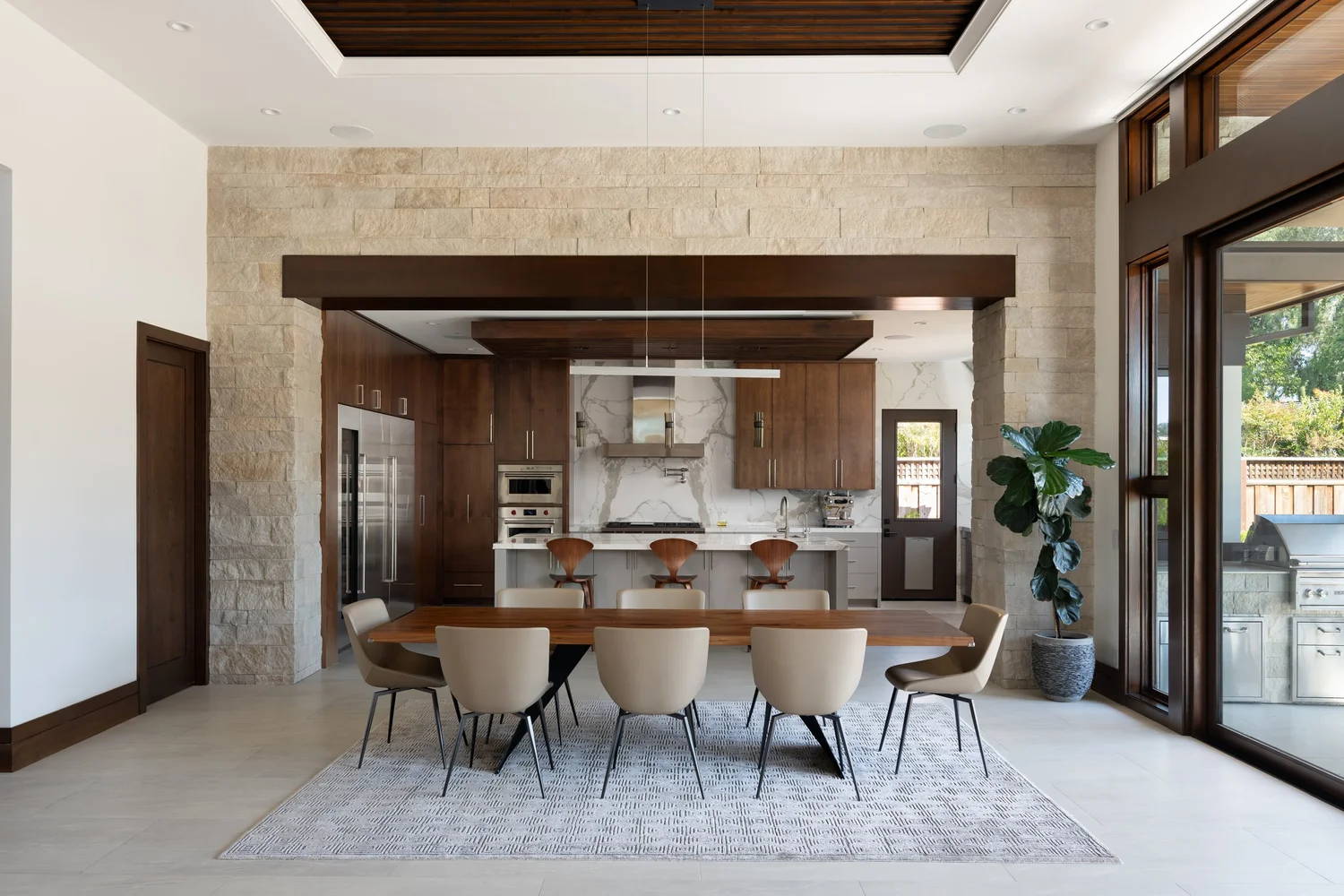 Buff coursed veneer in a split face with dry-stack joints on an interior dining room wall.