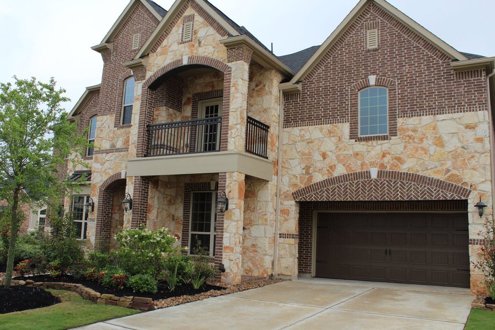 Rustic Earth mosaic veneer in split face framing a facade entry.