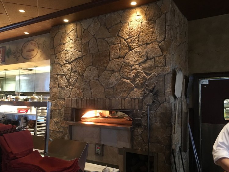 Tuscany Gold field veneer on an interior wall in split and natural faces with raked joints.