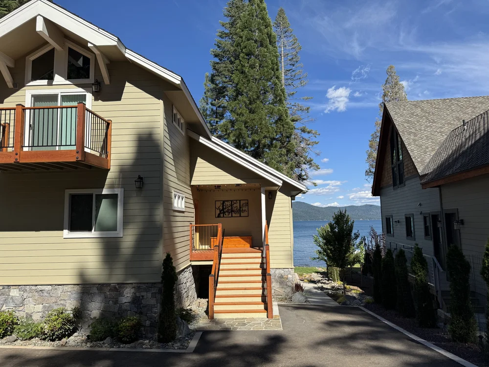 Gallatin River veneer forming a home's stone base along a garden walkway.
