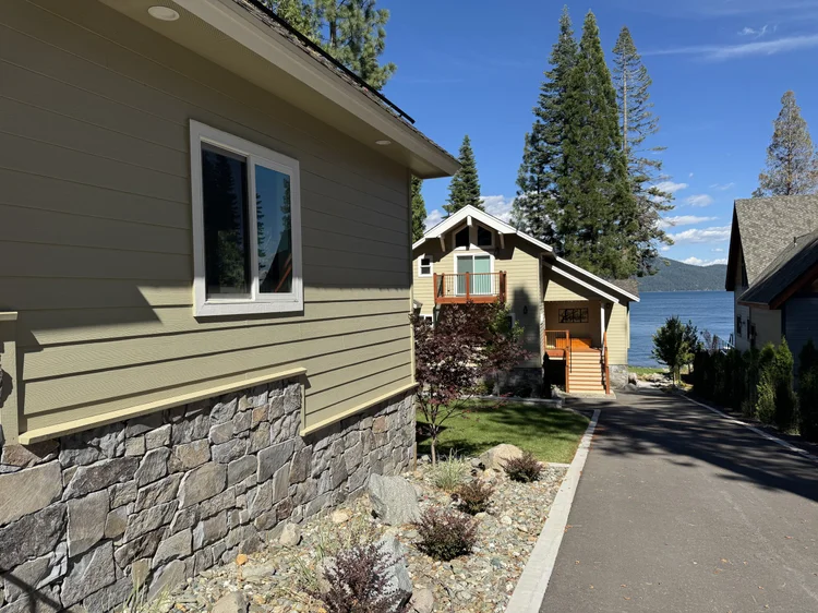 Gallatin River veneer on the stone piers and chimney of a lakeside home.