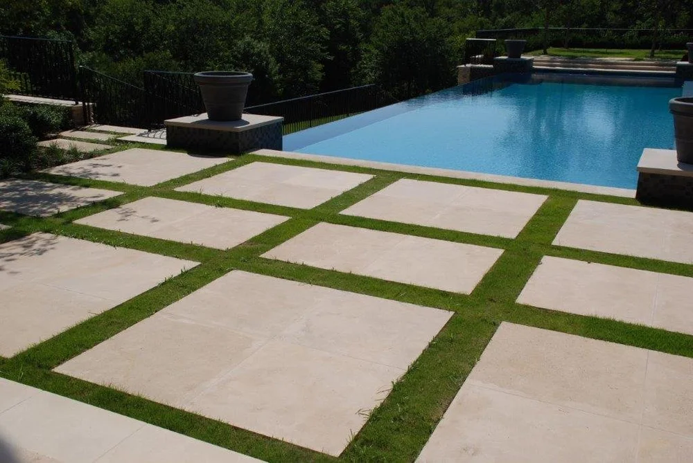 Honed Onaga pavers with matching coping and wall caps around a pool.