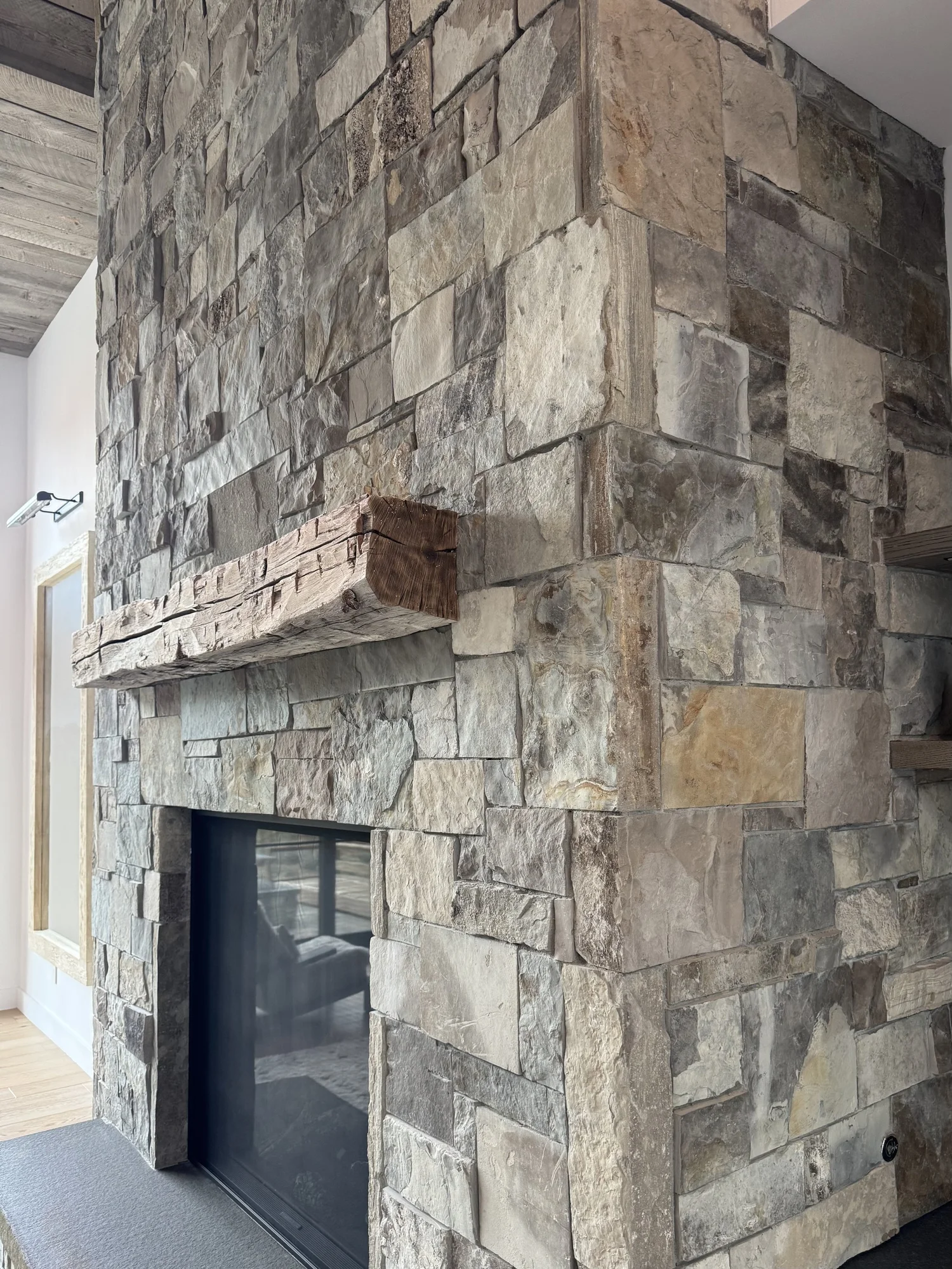 A double-height interior fireplace clad in split-face Canyon River veneer.