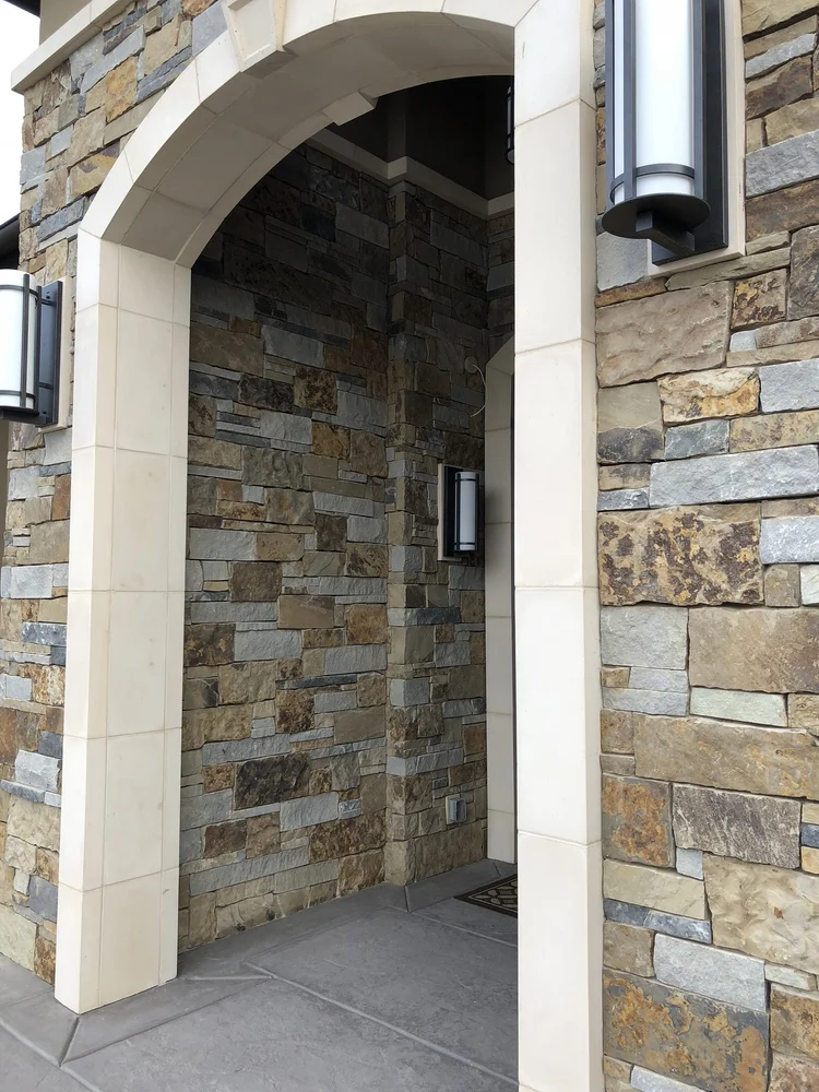 Monterey Estate ashlar veneer in split and natural faces with dry-stack joints across a home facade and entry.