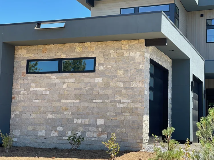 An Avalon wall carries a narrow clerestory window beside the garage bays.