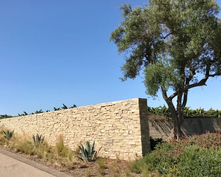 Lompoc split-face ashlar veneer dry-stacked across a garden wall.