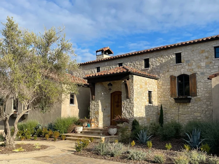 Tuscany field veneer and Indiana Limestone sills, lintels, and keystones framing a facade entry.