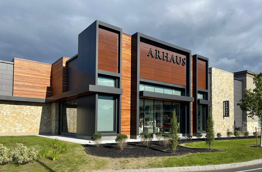 Tuscany Bronze mosaic veneer framing a facade and entry in split and natural faces with flush joints.