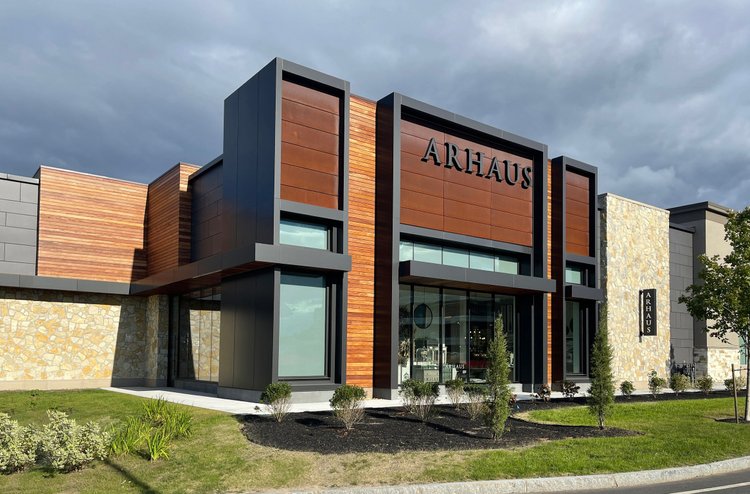 Tuscany Bronze mosaic veneer framing a facade and entry in split and natural faces with flush joints.