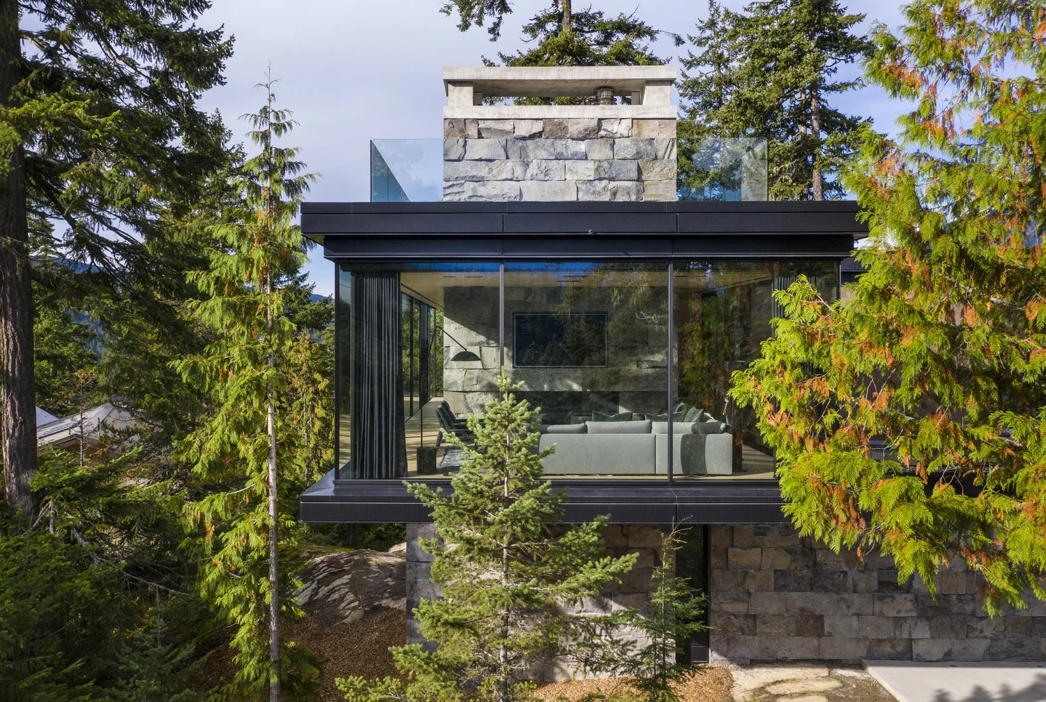 Whistler Basalt panel veneer in a natural face with dry-stack joints on a facade with a fireplace.