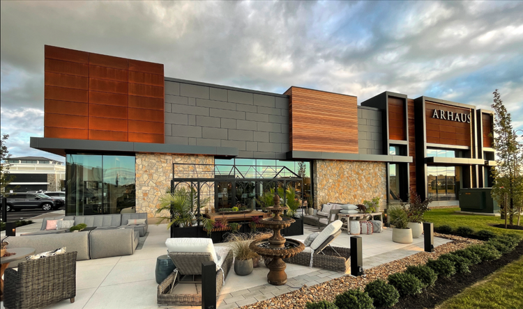 Tuscany Bronze mosaic veneer wrapping a facade and entry in split and natural faces with flush joints.