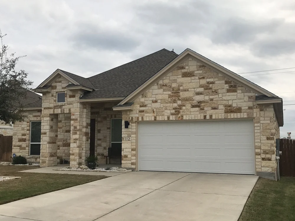 Cave Blend split-face ashlar veneer across a facade and entry.