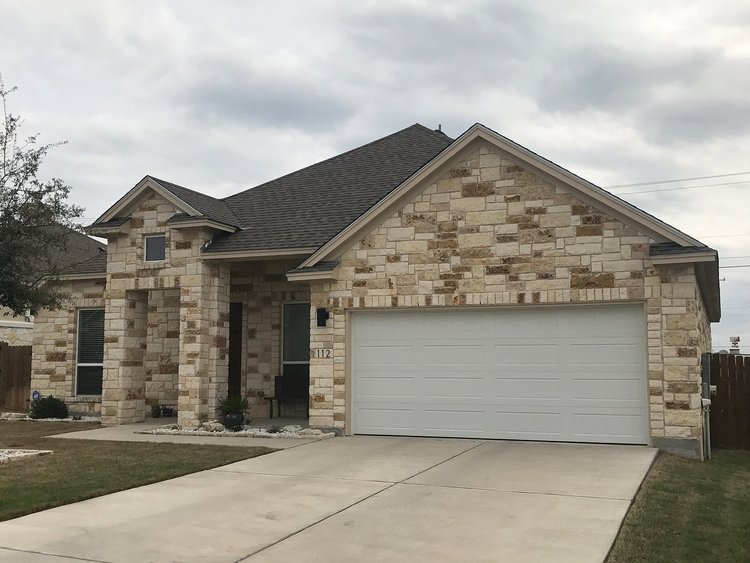 Cave Blend split-face ashlar veneer across a facade and entry.