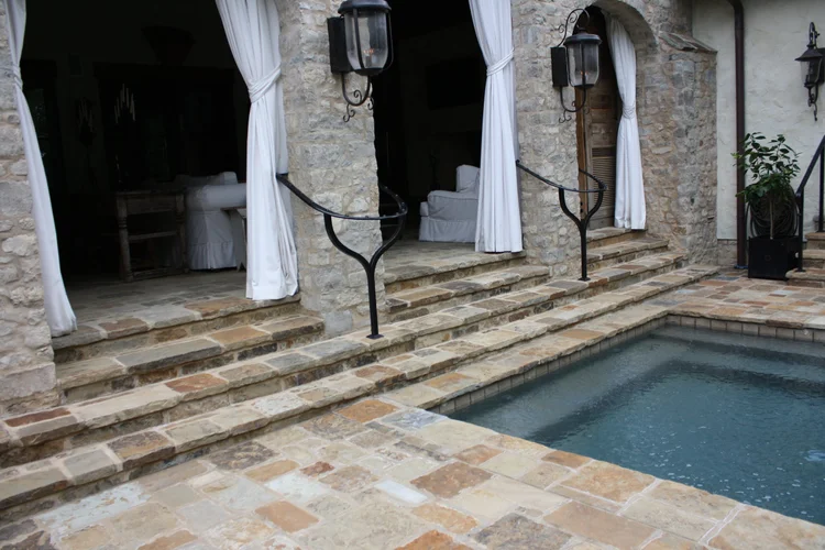 Desert Mountain dimensional pavers in a natural finish across a poolside patio.