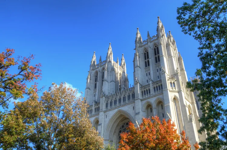Honed-faced Indiana Limestone panel veneer with Indiana Limestone wall caps, column caps, sills, lintels, jambs, keystones, monuments, corbels, and custom pieces across the cathedral facade.
