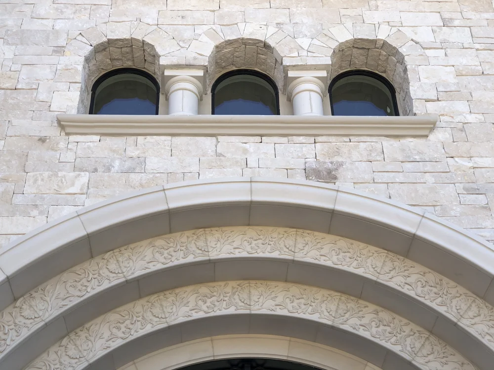 Sea Fossil ashlar veneer in split and natural faces with dry-stack joints on a facade.