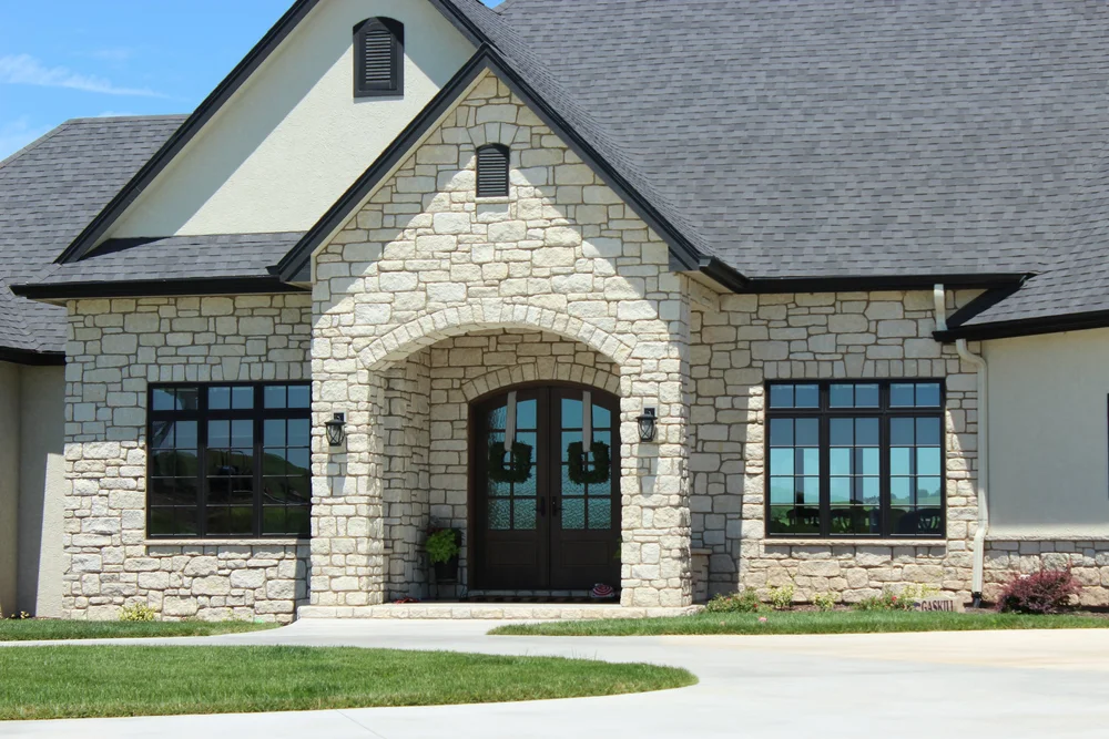 Tumbled Silverdale ashlar veneer softening a facade and entry.