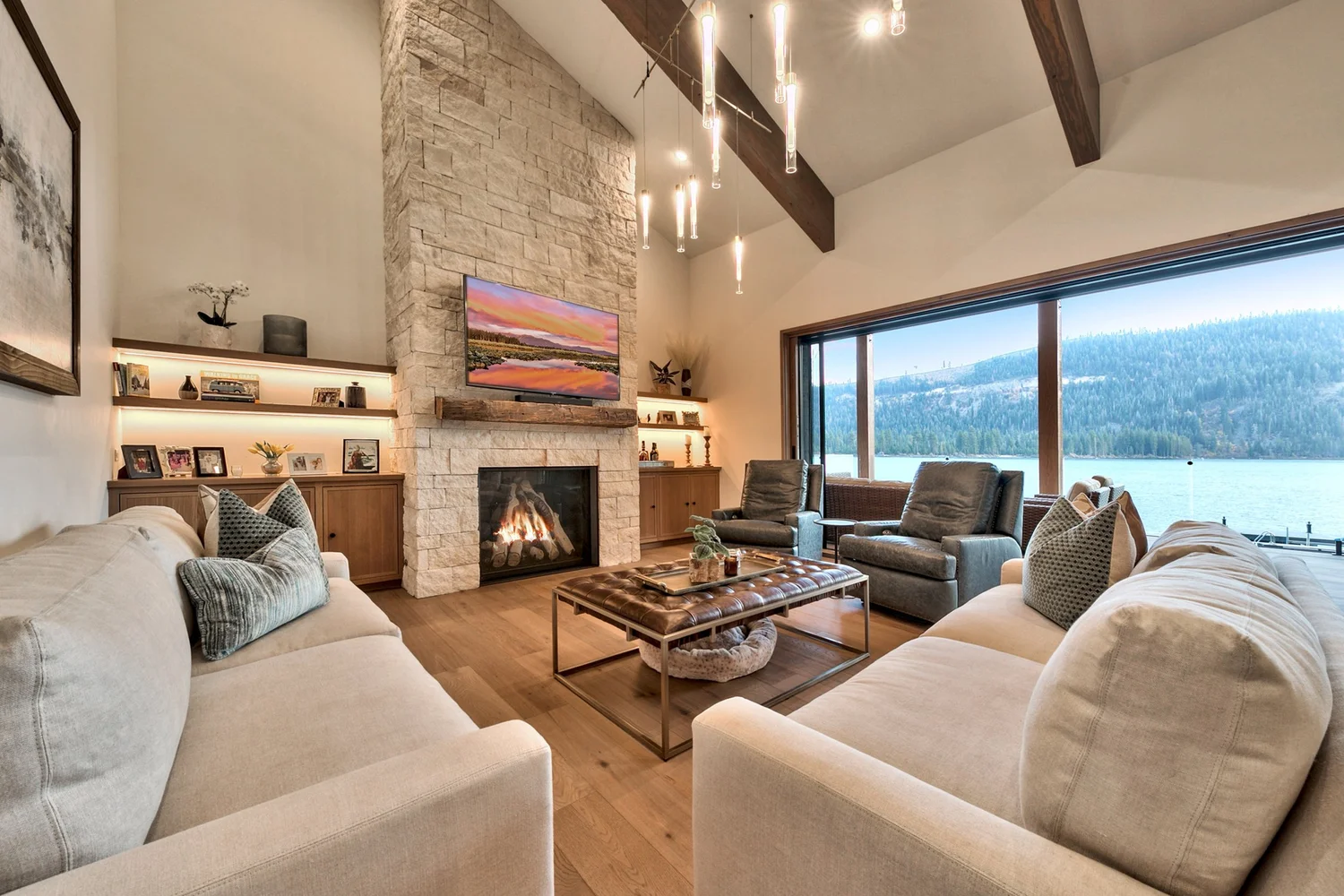 Cream split-face ashlar climbing a vaulted great-room fireplace wall.