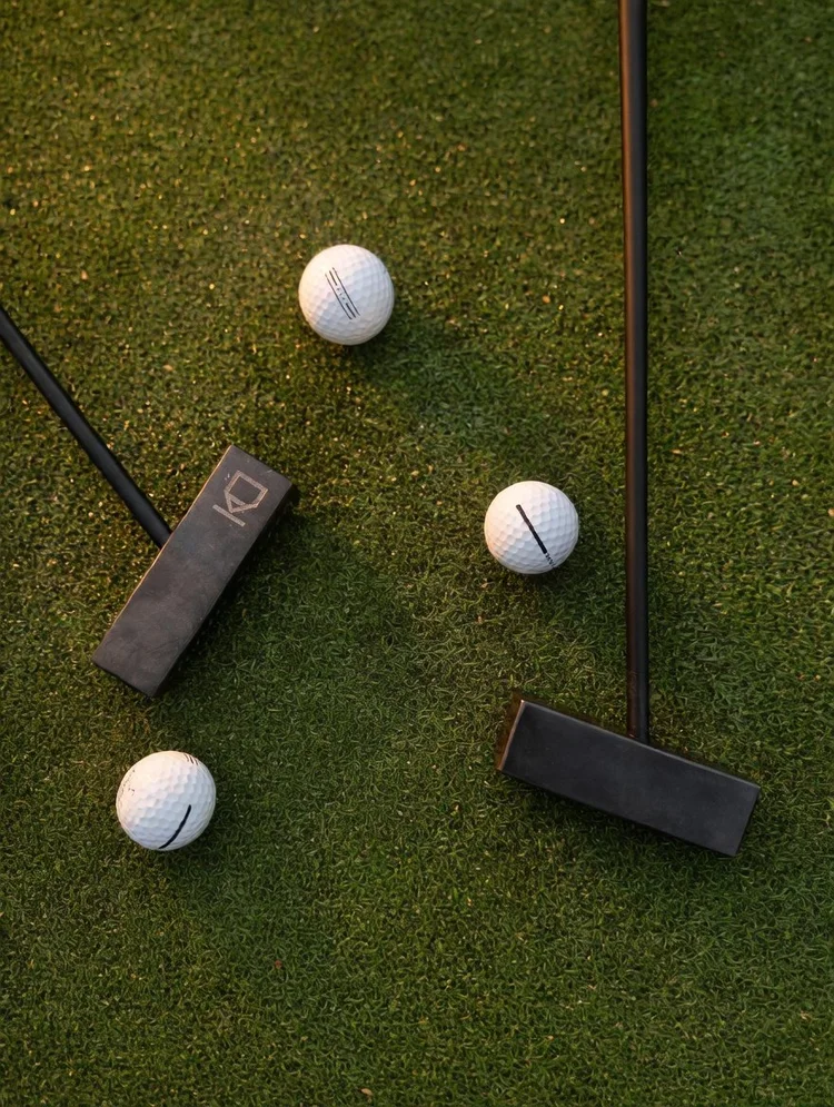 The Kő Putter, a honed Black Mountain stone golf putter.