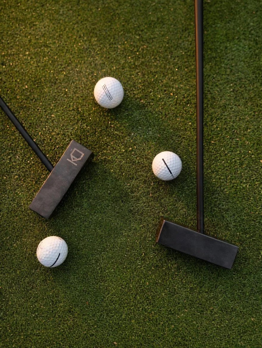 The Kő Putter, a honed Black Mountain stone golf putter.