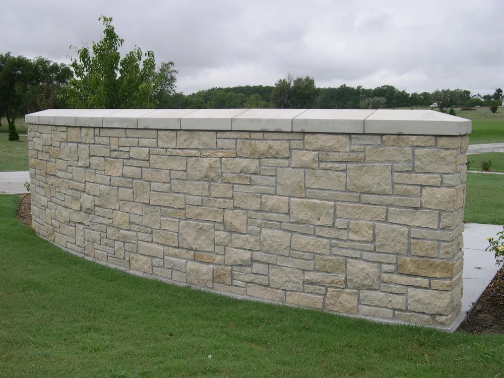 Split-face Silverdale ashlar veneer along a garden wall.