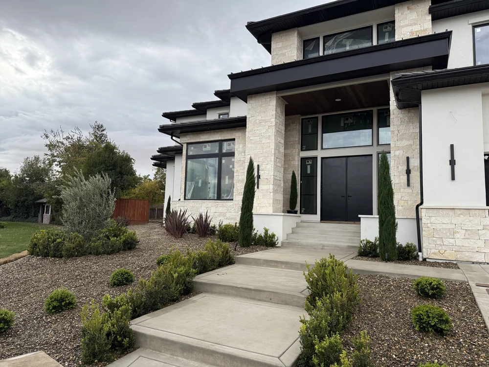 Sea Fossil ashlar veneer with dry-stack joints and honed Sea Fossil wall and wainscot caps at an entry.