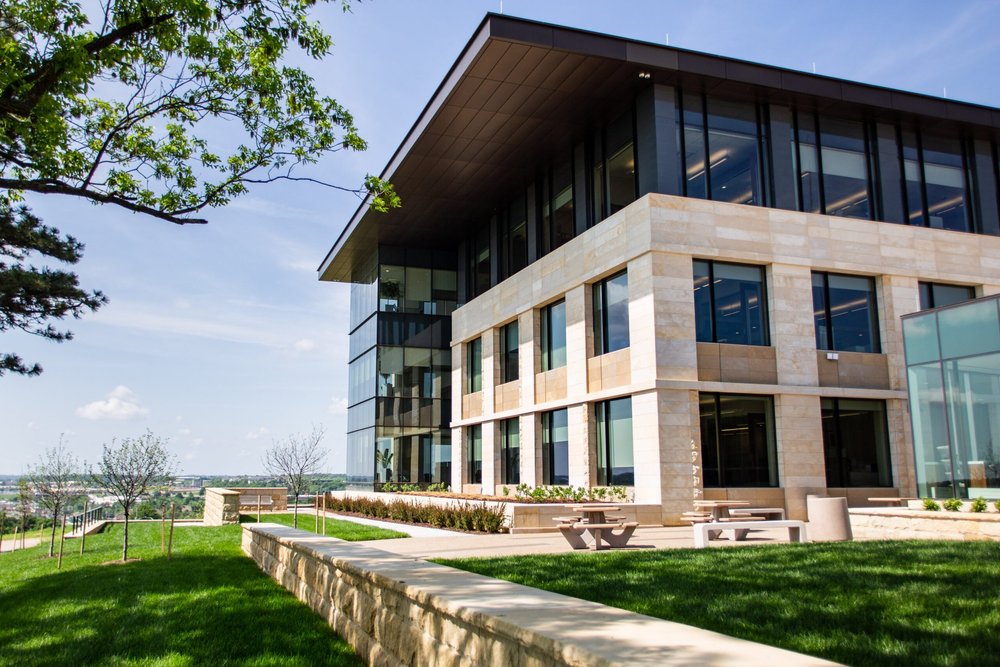 Onaga ashlar veneer with honed panel veneer and column caps across a bank facade.