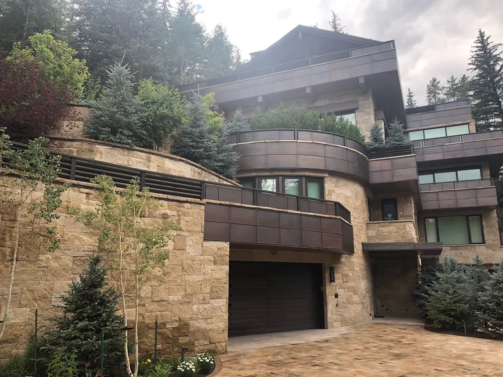 Chestnut Shell split-face ashlar veneer across a facade and entry.