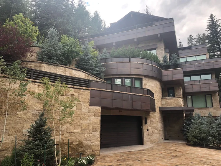 Chestnut Shell split-face ashlar veneer across a facade and entry.