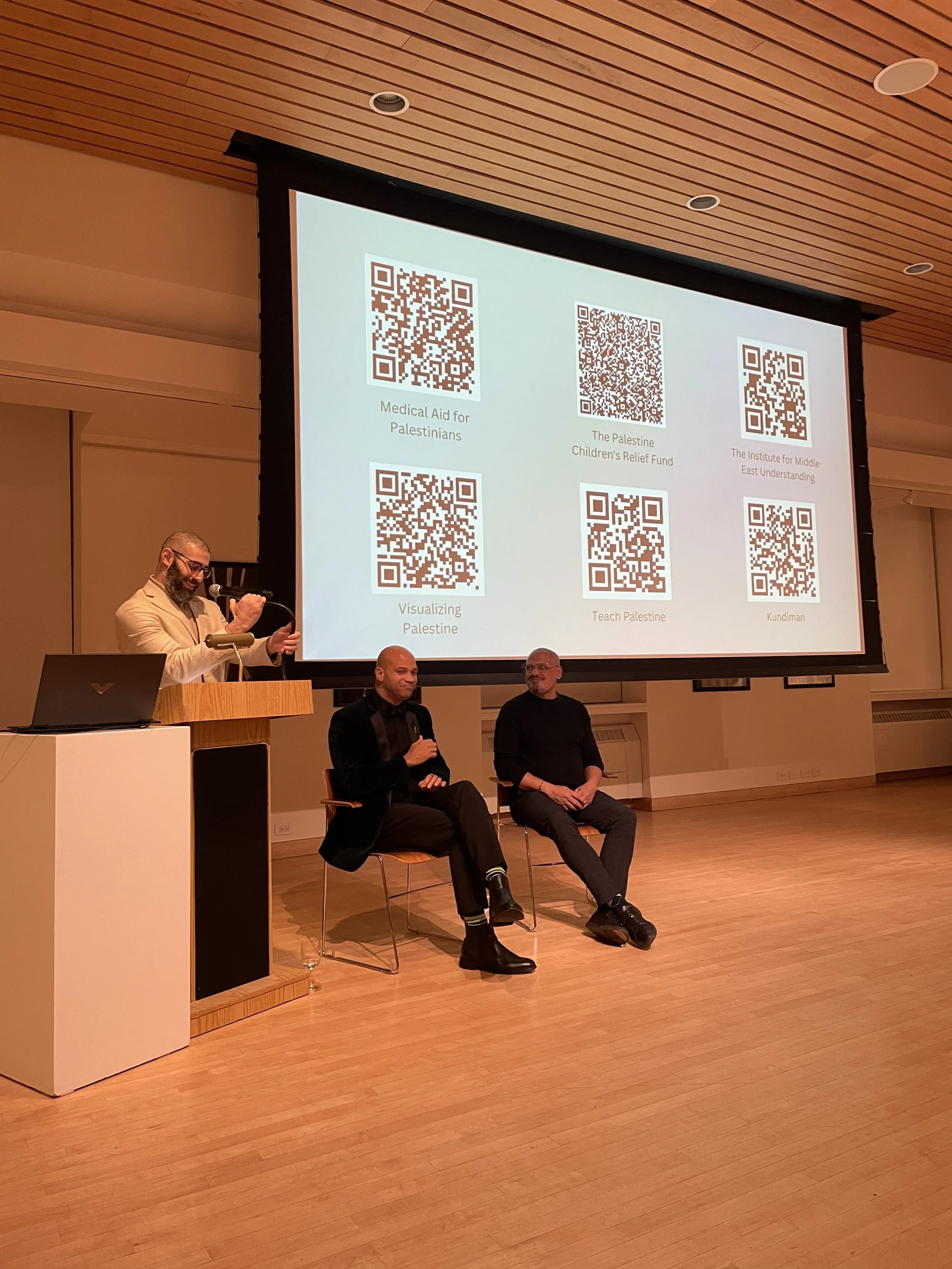 Tariq adjusting mic with a smile