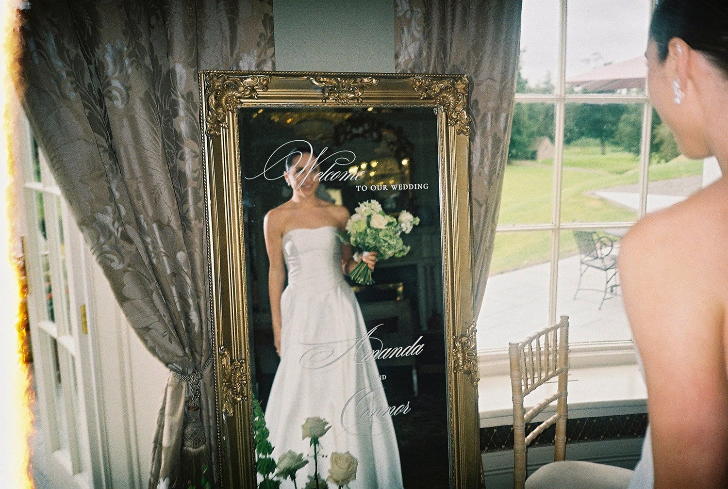 Bride reflected in a gilt mirror as she gets ready at The K Club, photographed on film