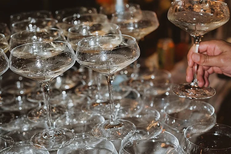 Rows of real coupe glasses set out on a Drink Slingers bar