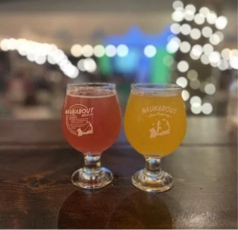 Two Naukabout beers with evening lights