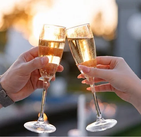 Two champagne glasses raised in a toast
