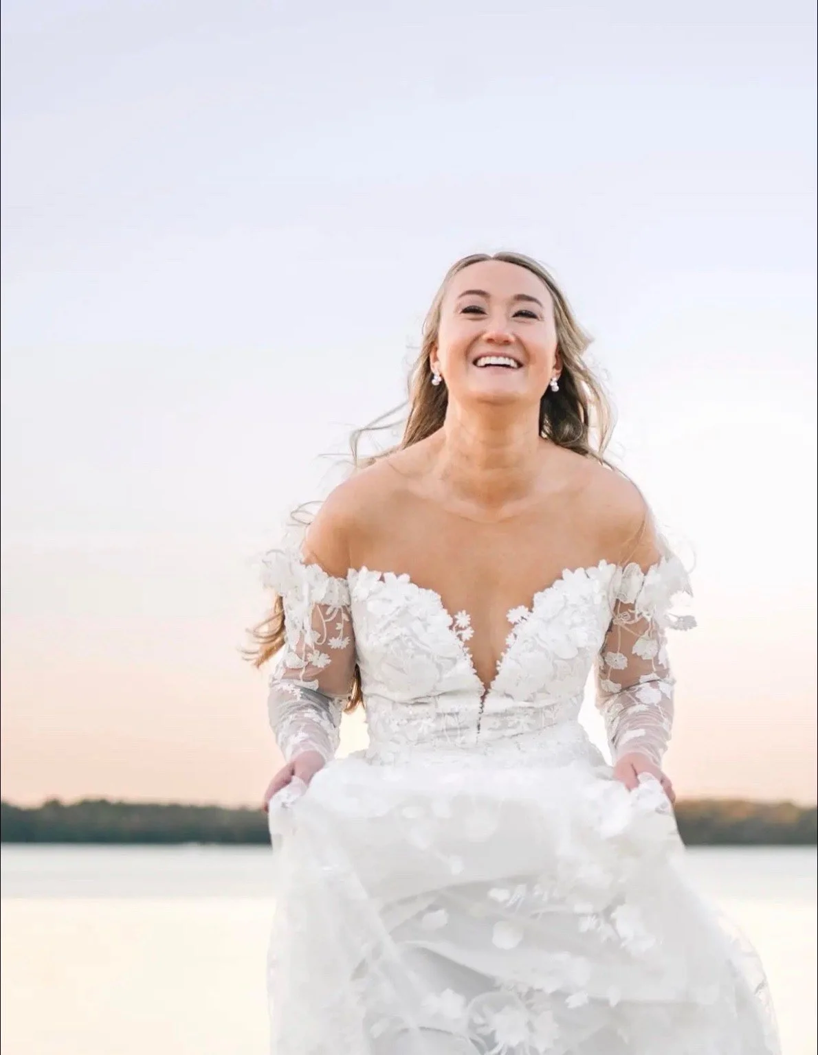 A bride standing beside the water