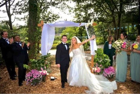 An outdoor wedding ceremony by the water