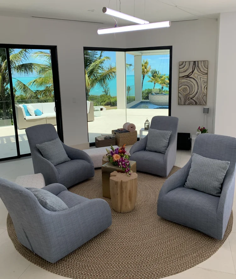 Ocean-view sitting area with a linear LED pendant in the Turks & Caicos house