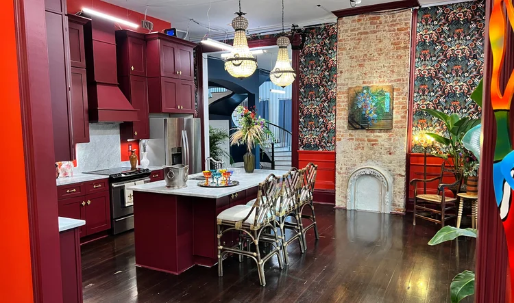 Kitchen and exposed-brick fireplace with beaded chandeliers in the New Orleans house