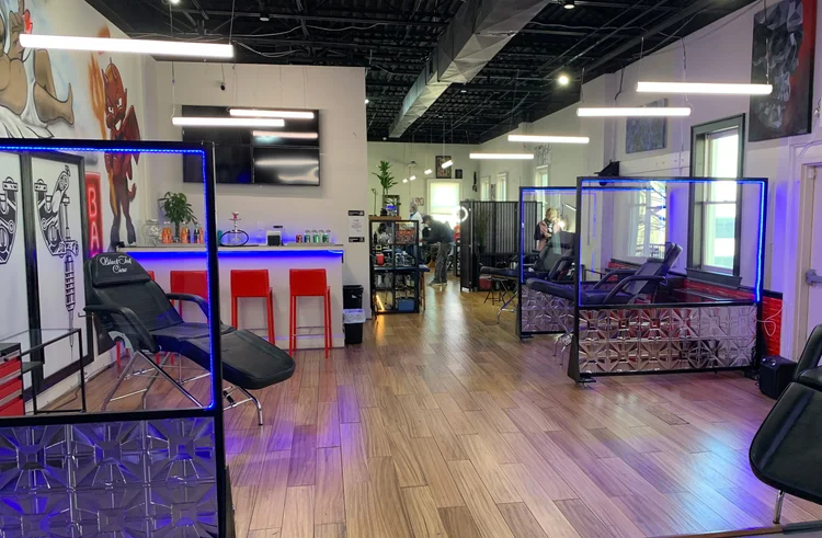 Black Ink Crew tattoo shop fitted with suspended linear and colour-changing LED edge lighting by The Camera EYE