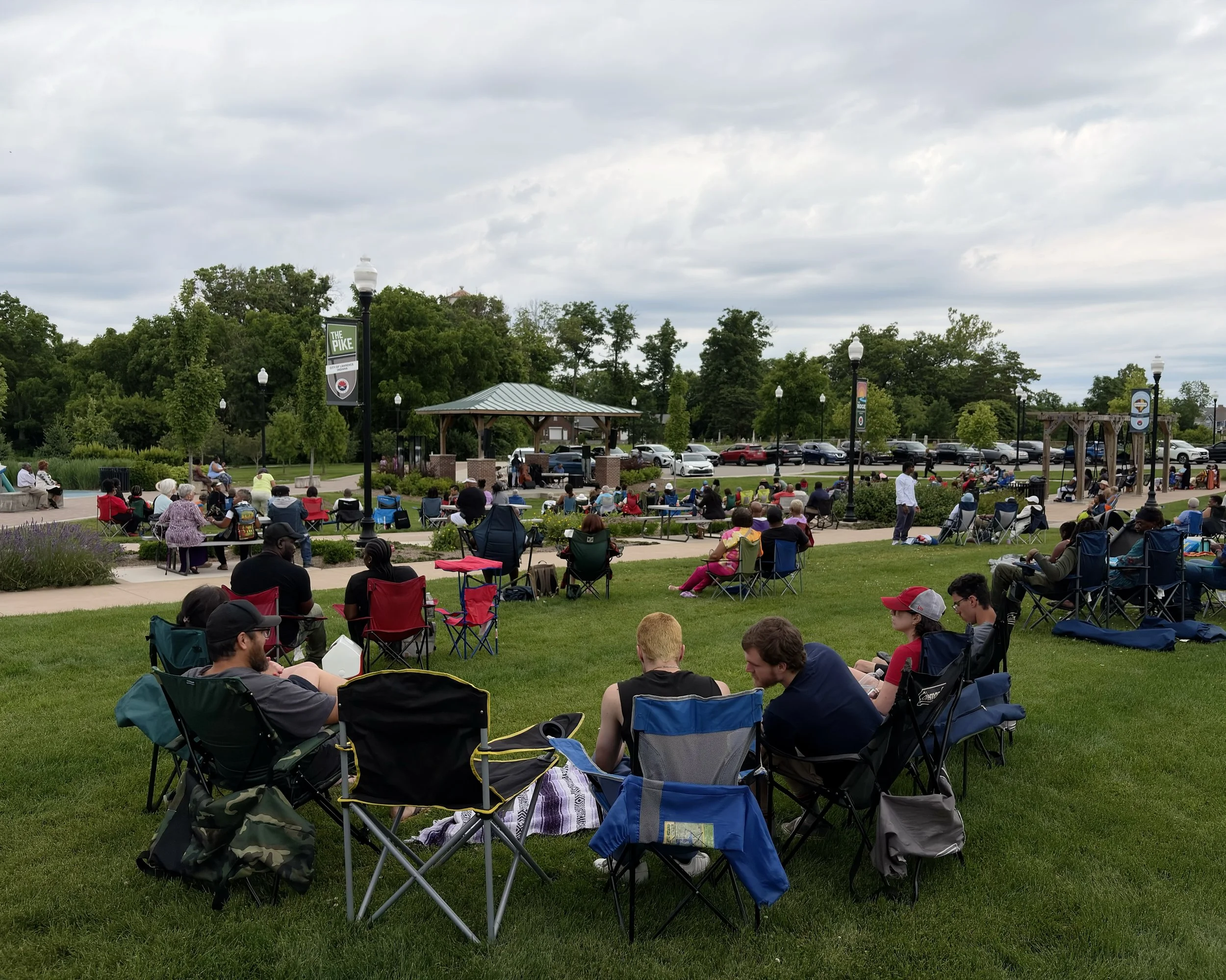 Concertgoers enjoying live jazz across the amphitheater lawn