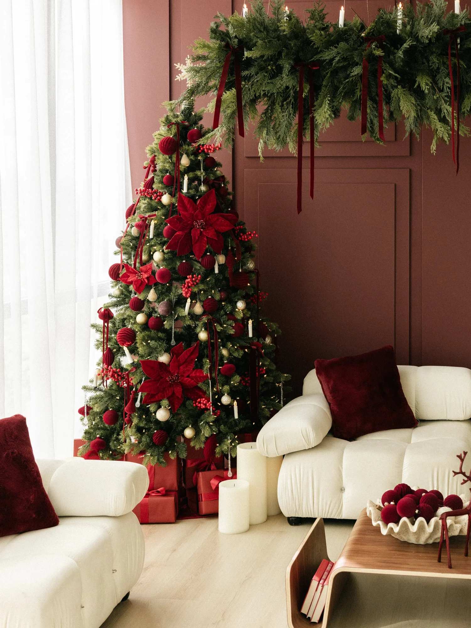 Red Velvet Chic Christmas set with tree, ivory sofa and burgundy walls