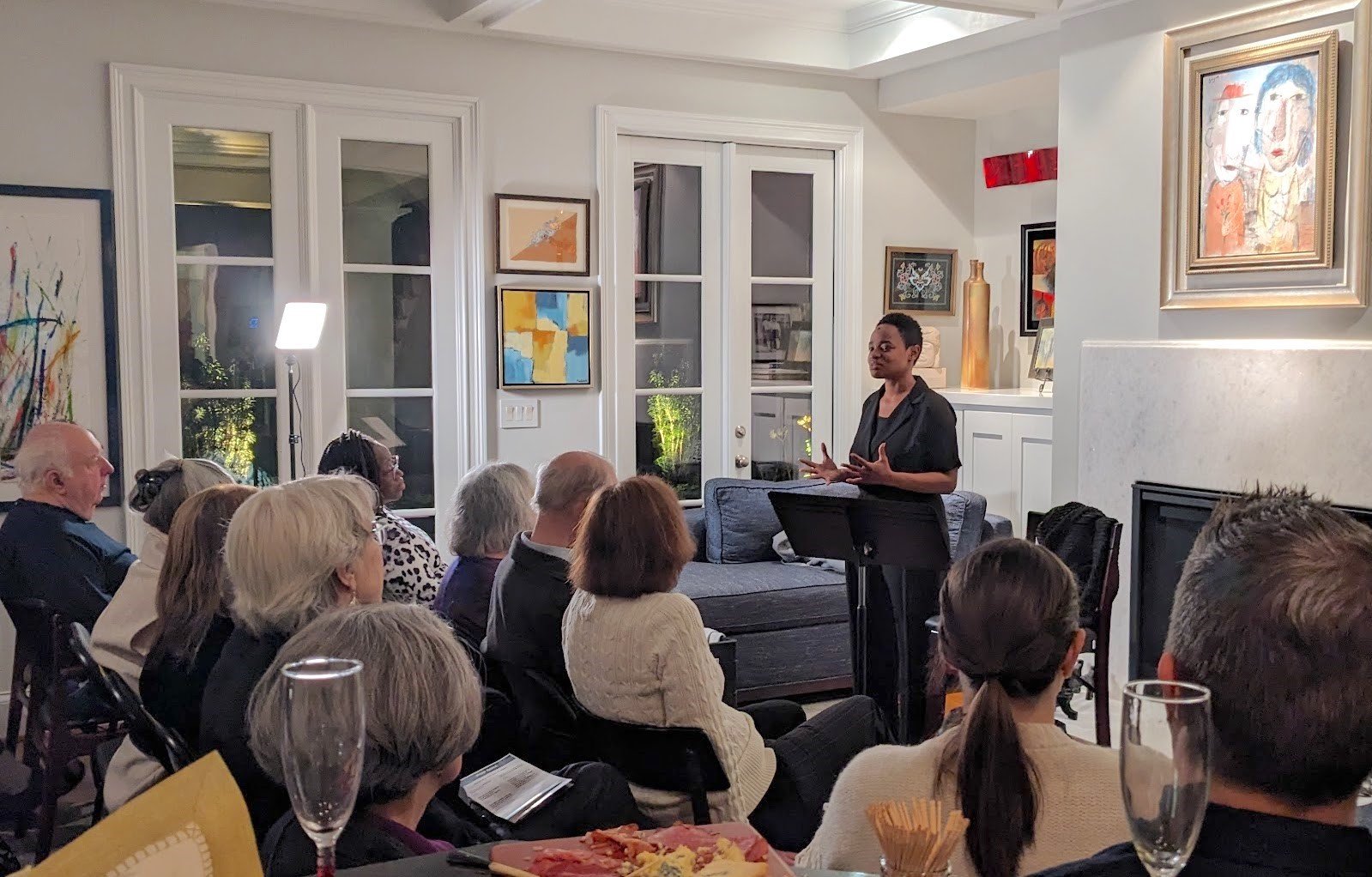 Dionna D. Davis performing Class Dismissed before an audience in a home