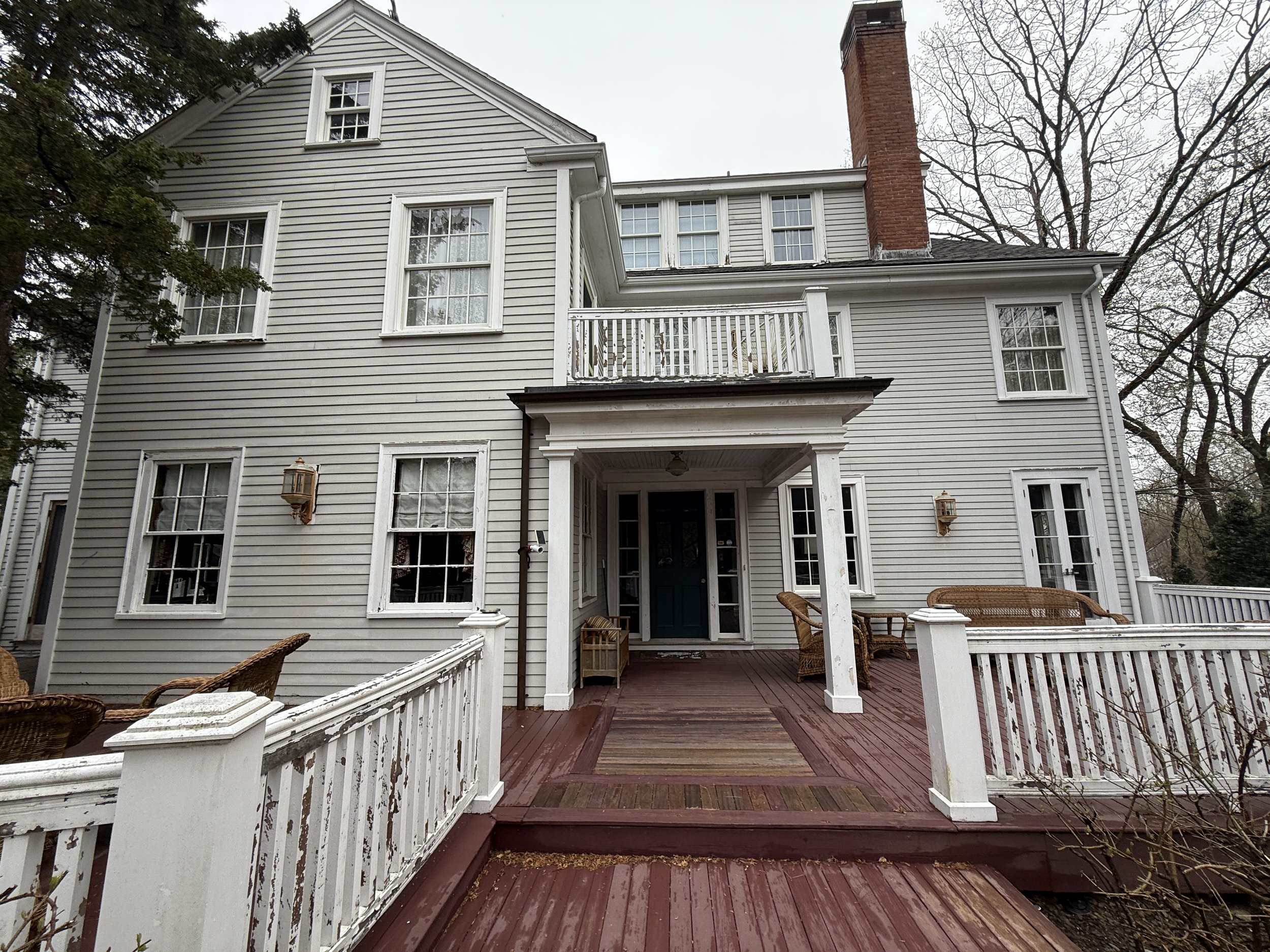Massachusetts colonial before Smart Domain renovation — peeling paint, dated decking