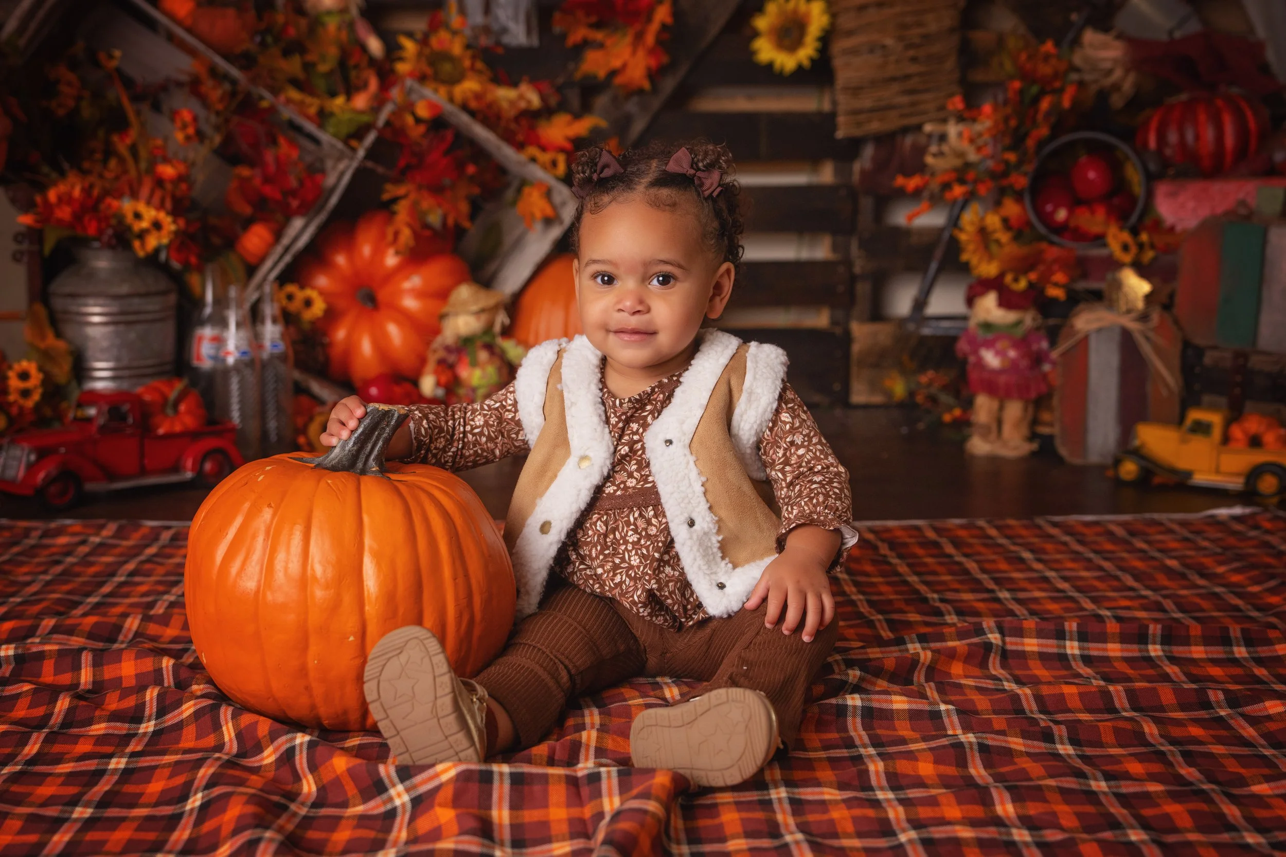 Seasonal portrait with hay pumpkins and leaves