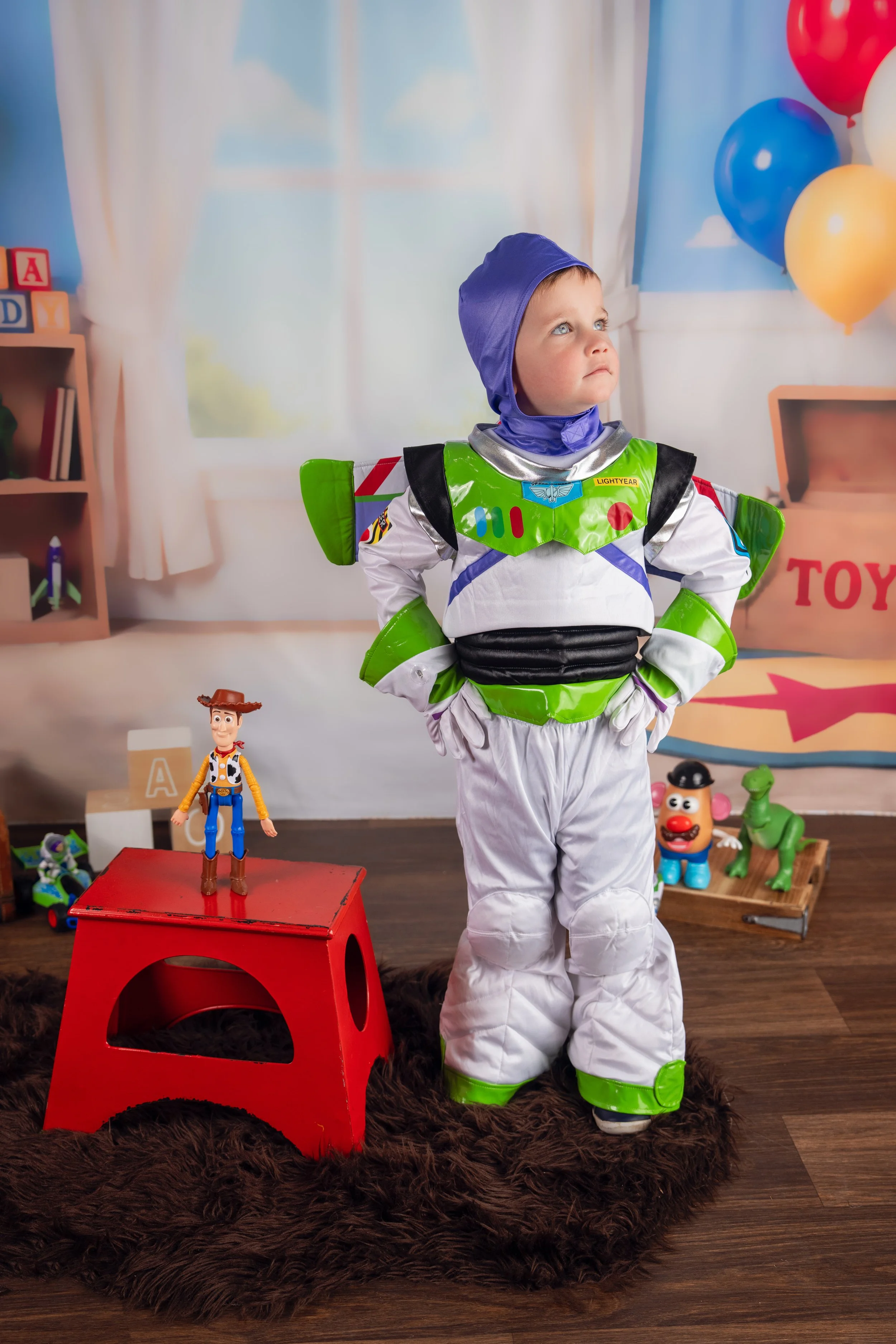 Child posing with favorite playroom toys